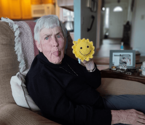 Boise homeowner showing off her Bring a Little Sunshine sunflower for Quality Heating & Cooling contest.